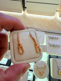 Original owner reference — Yellow Gold U Link Drop Earrings in the foreground. Background jewellery and the display holder are not included.