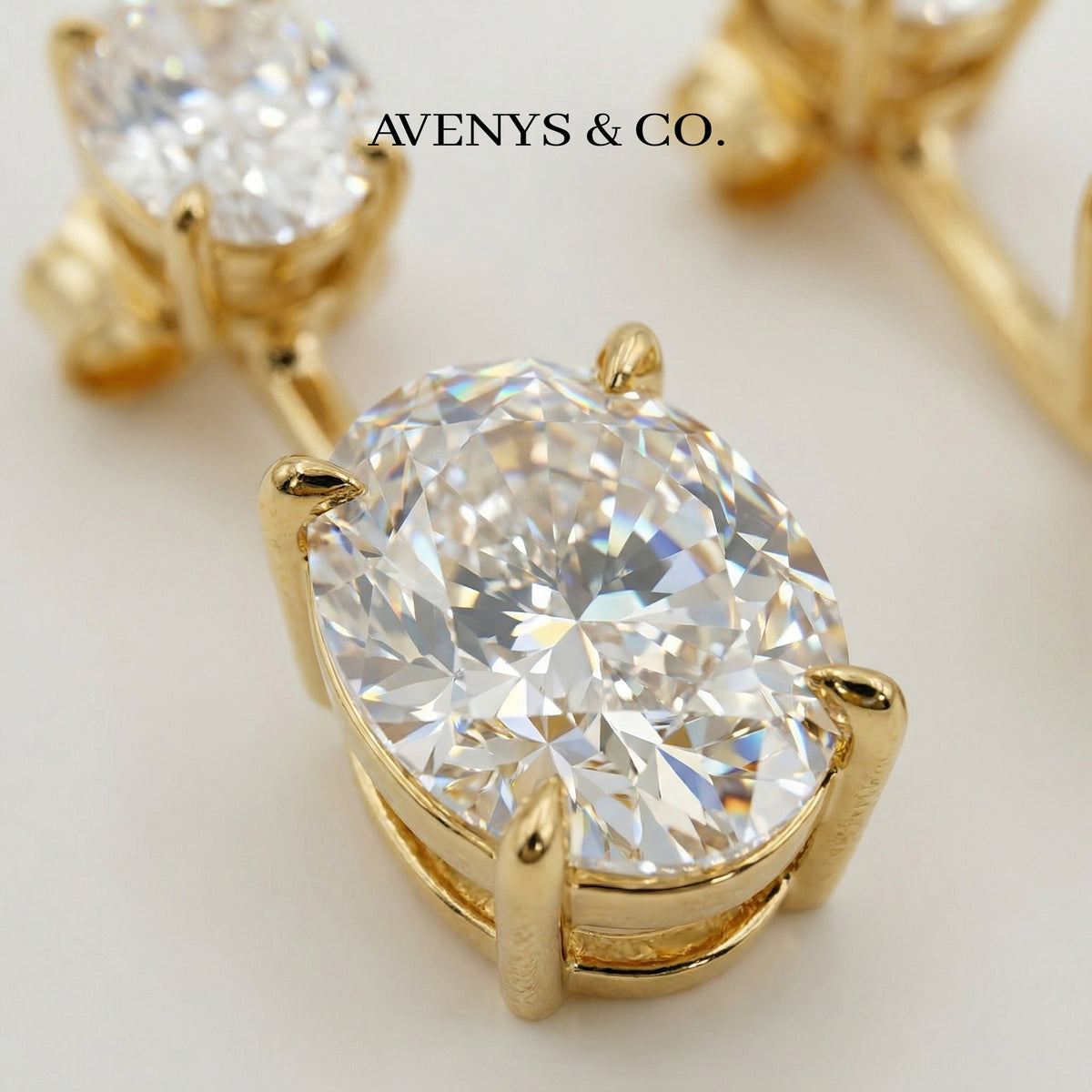 Air Drop Earrings with White Oval Stone – on Yellow Gold