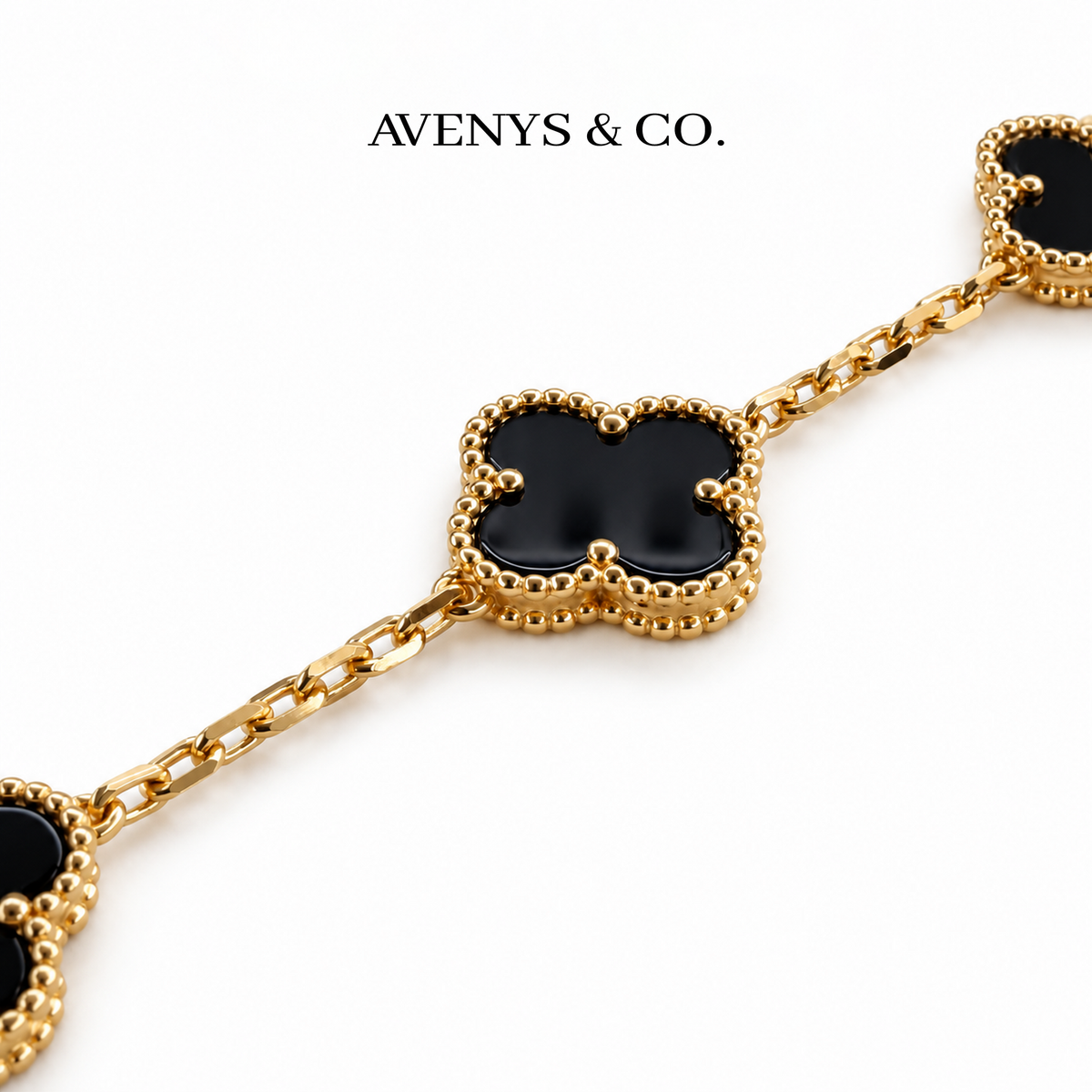 Black motif, beaded yellow gold border and faceted chain detail