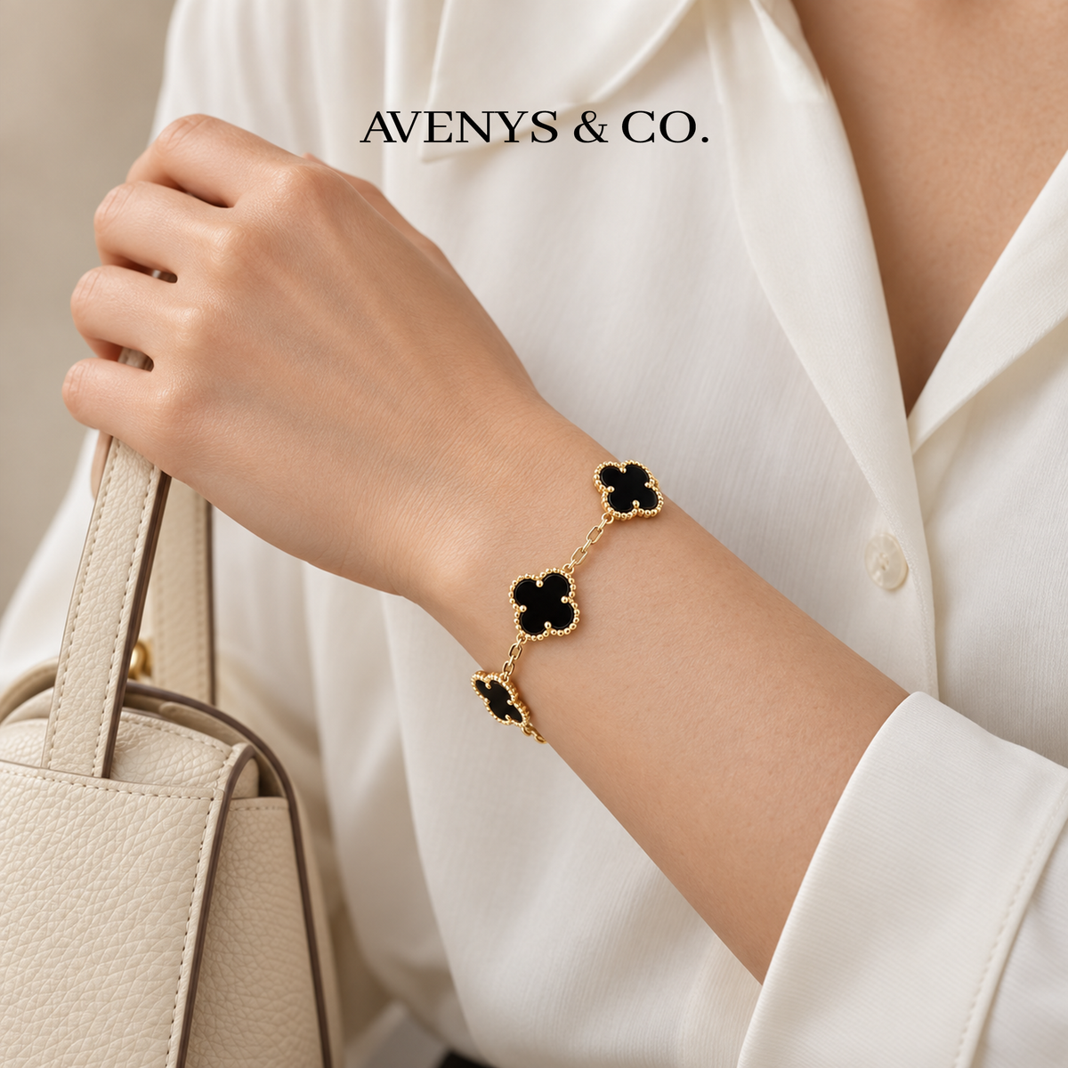Black five-motif bracelet in yellow gold styled with an ivory blouse