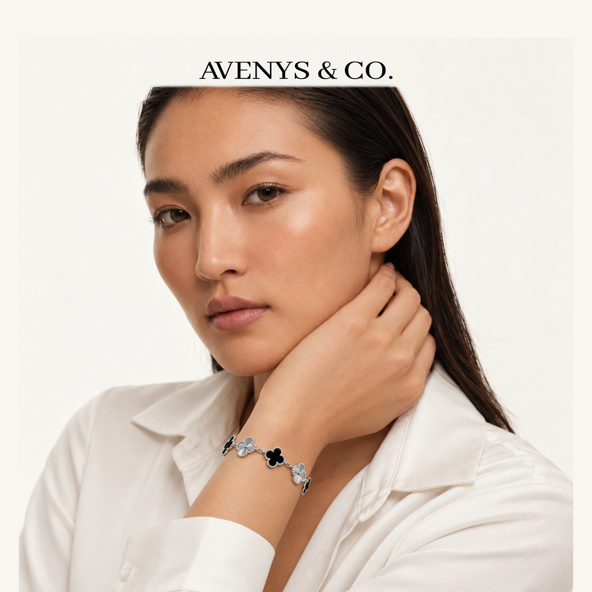 AV Bloom™ Black & Silver Sunburst Bracelet with a white blouse