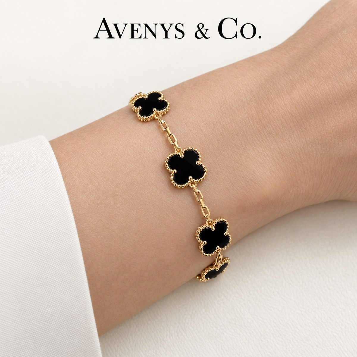 Black five-motif bracelet in yellow gold worn on a wrist