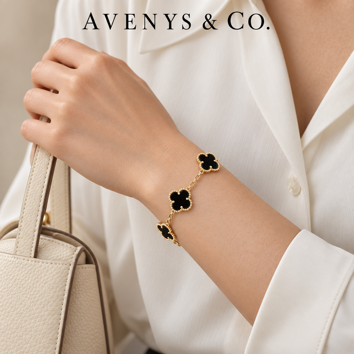 Black five-motif bracelet in yellow gold styled with an ivory blouse
